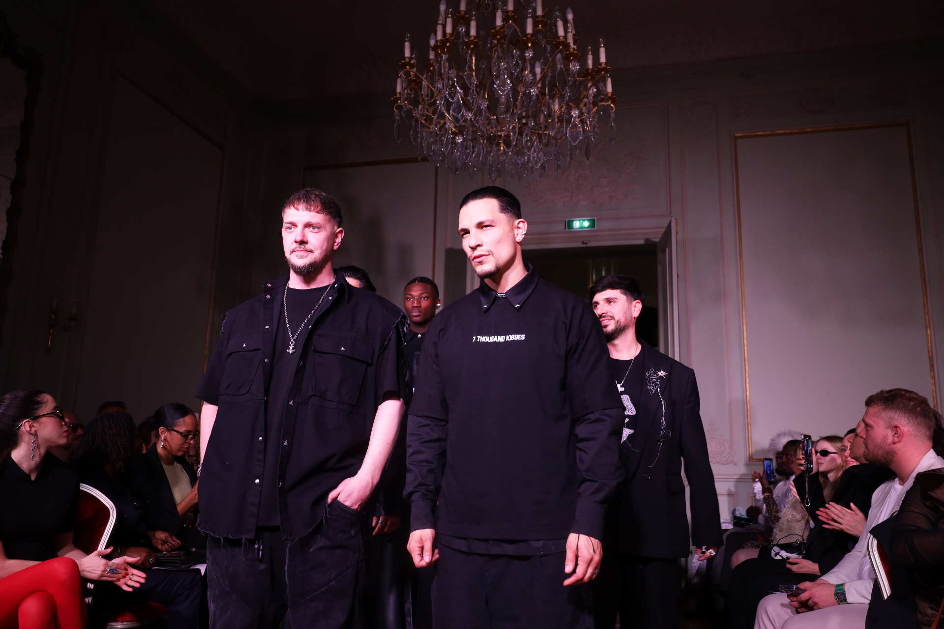Designers walking the finale under the chandelier