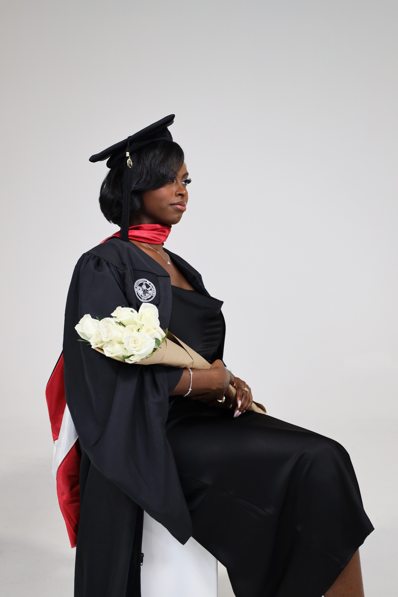 Studio graduate portrait with white roses and satin stole