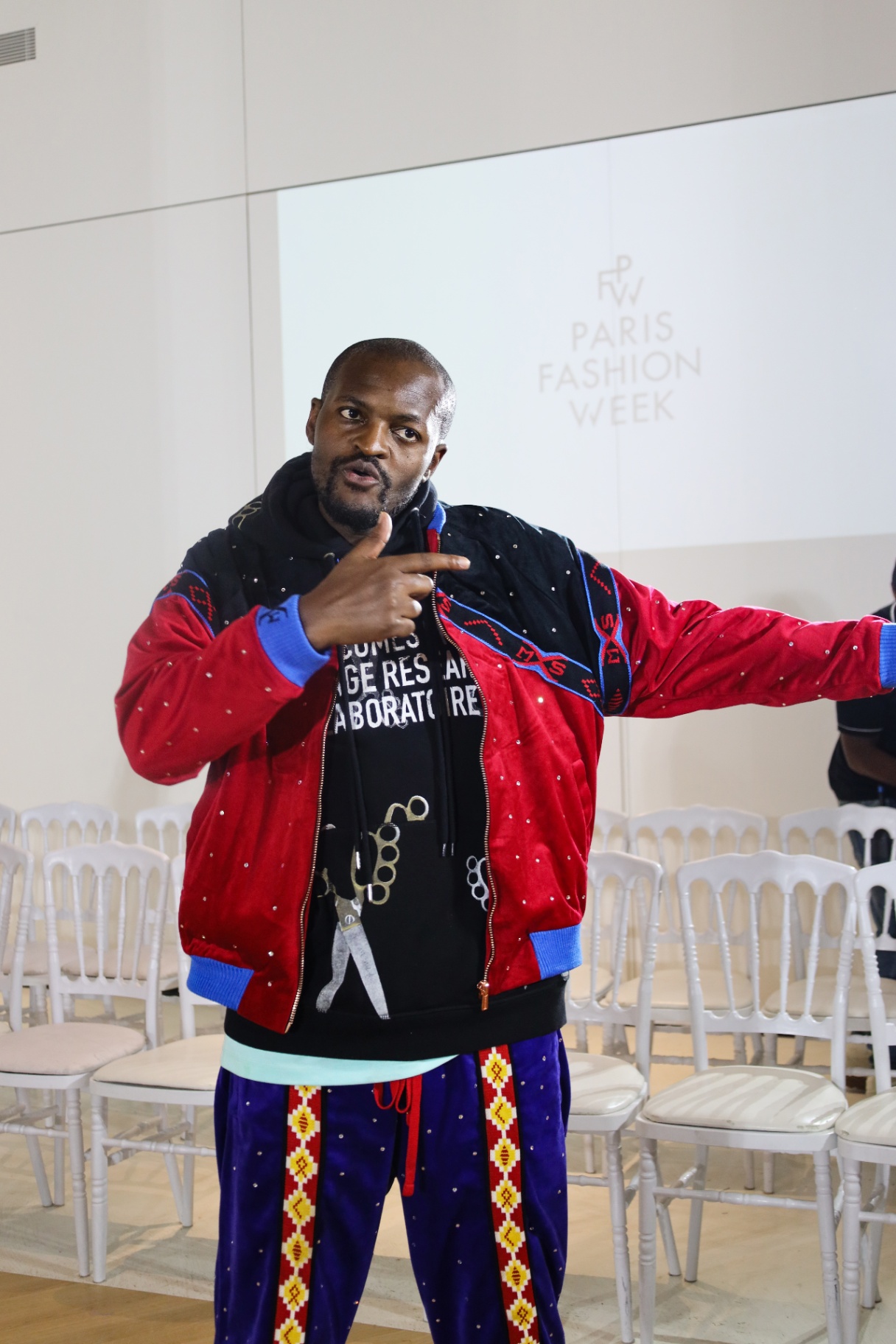 Designer addressing the room at Paris Fashion Week
