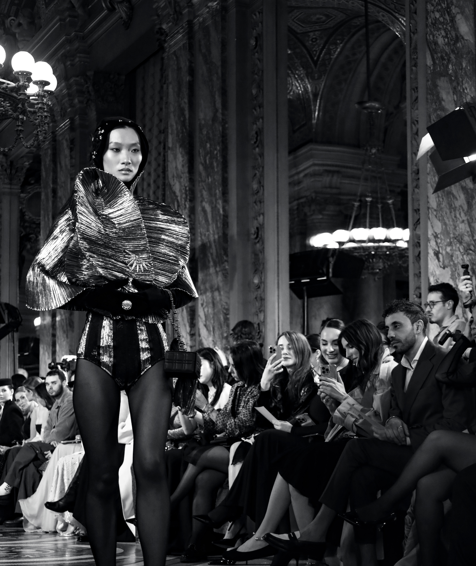 Black and white runway moment in pleated silver couture