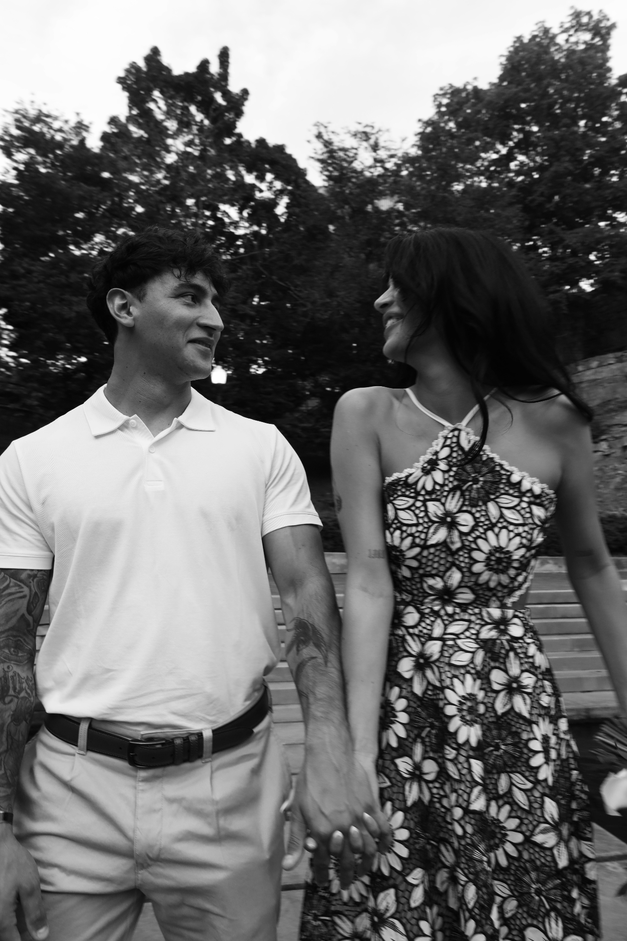 Black and white hand-holding portrait of the engaged couple