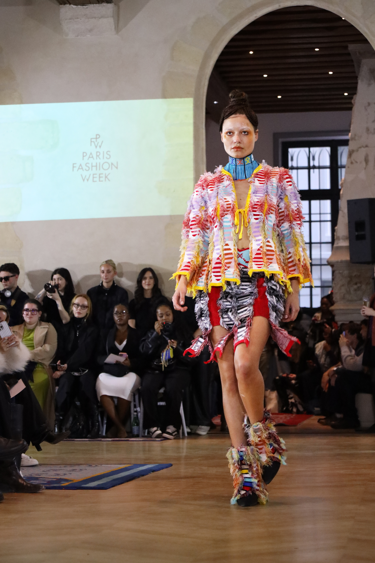 Paris Fashion Week look in fringed jacket and beaded collar