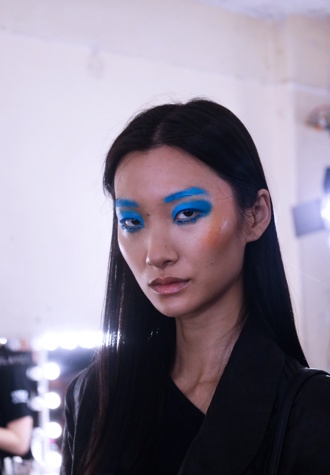 Model with electric blue brow and eye makeup