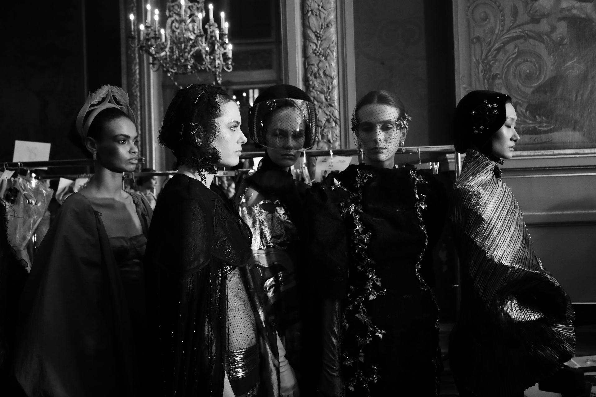 Black and white lineup of models in veiled headpieces