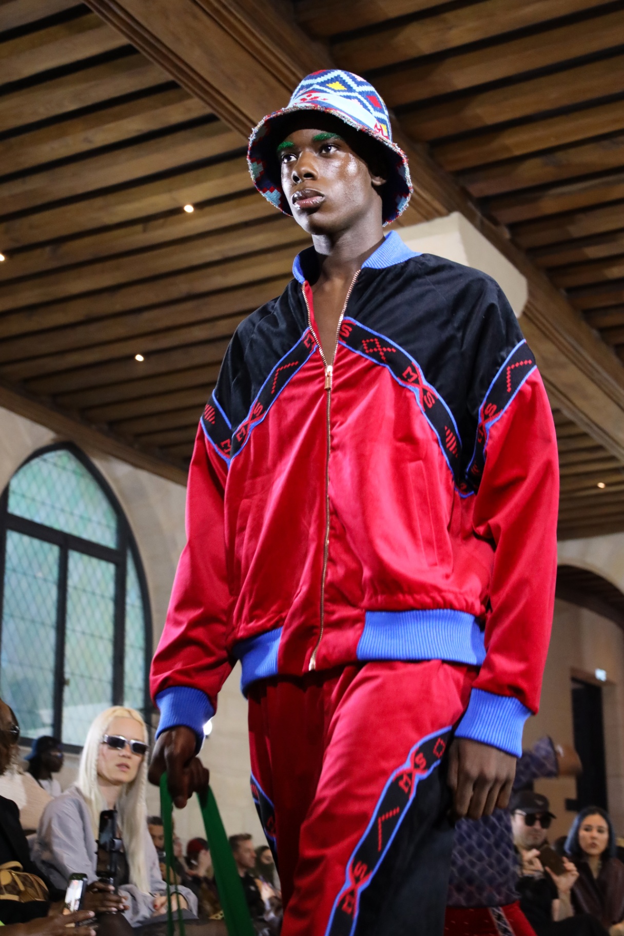Menswear look in red embroidered tracksuit and bucket hat