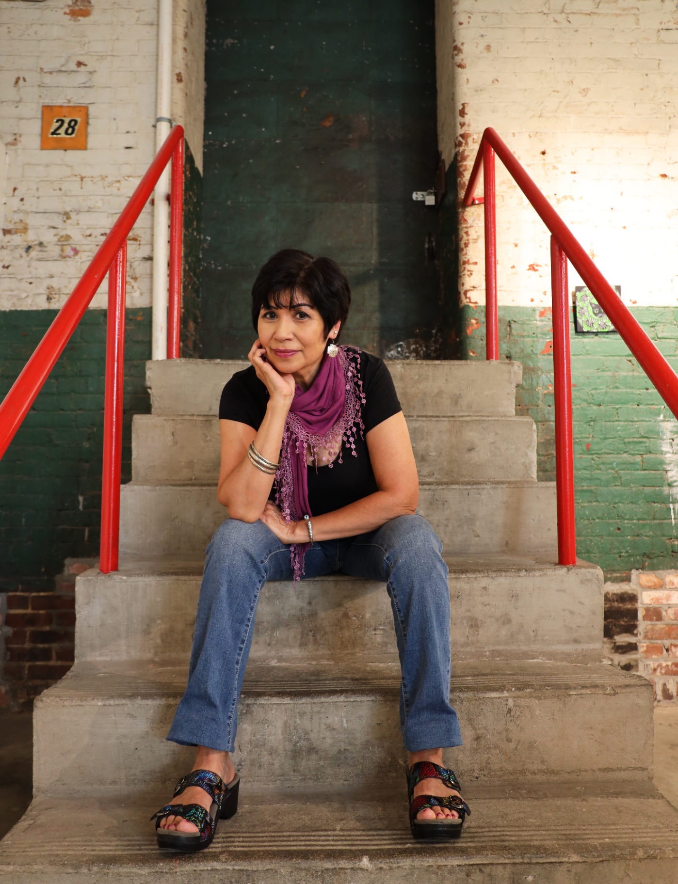 Portrait with red railings and weathered walls