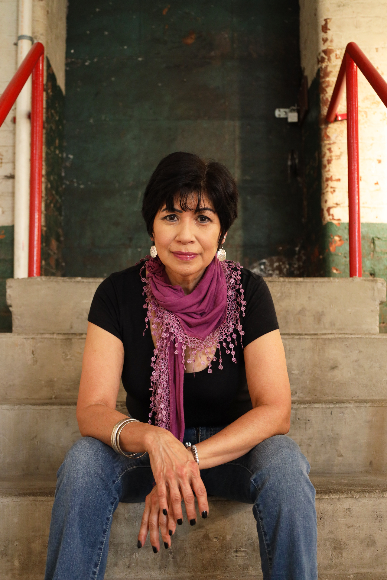 Portrait seated on industrial stairs