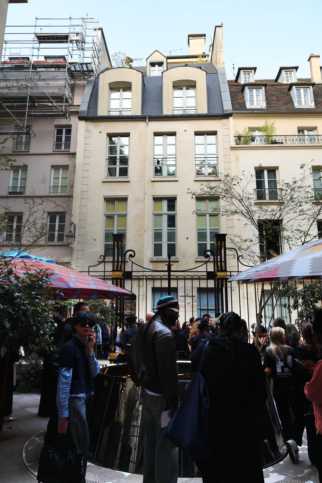 Guests gathered in a Parisian courtyard before the show