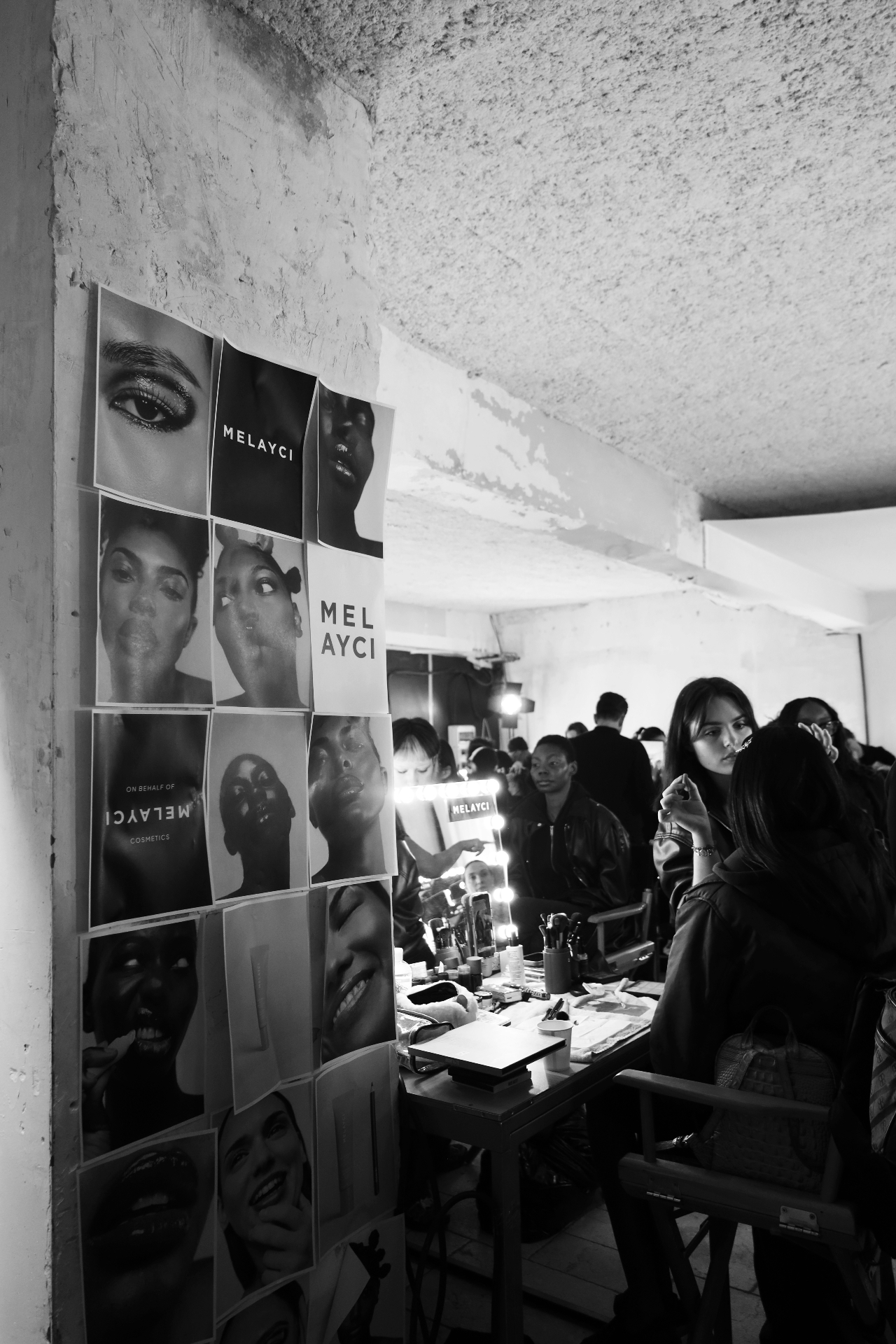 Melayci campaign wall backstage at the makeup mirrors